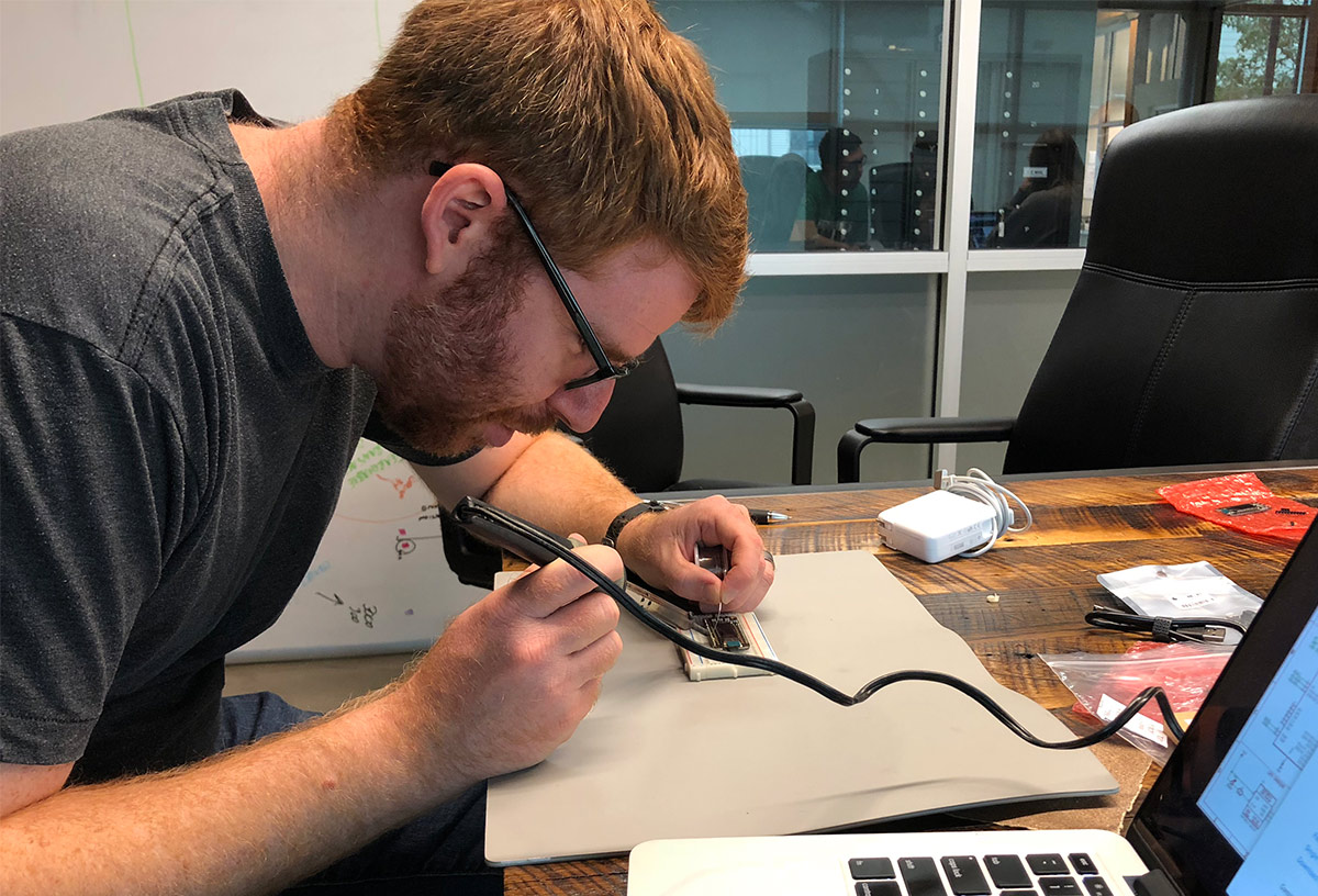 Josh shows Matt how to solder